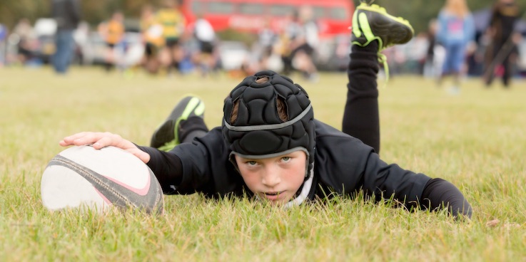 Boy playing rugby
