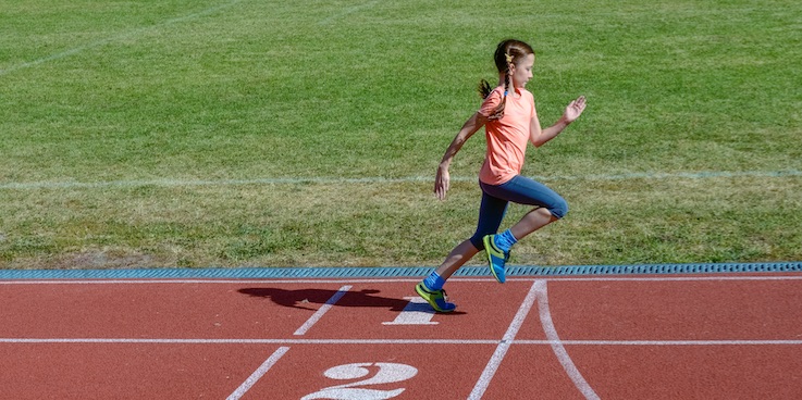 girl running on athletics track