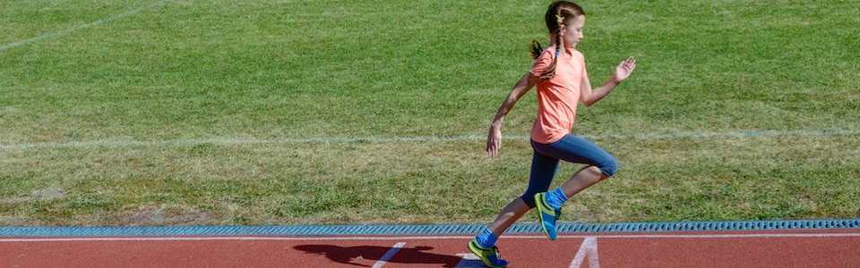 Girl running on athletics track